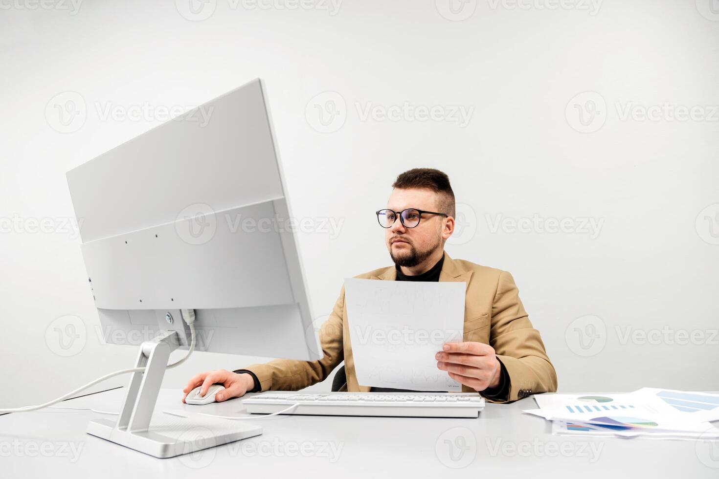 Thoughtful businessman working at a modern office desk. Concept of a confident and focused person solving important problems photo