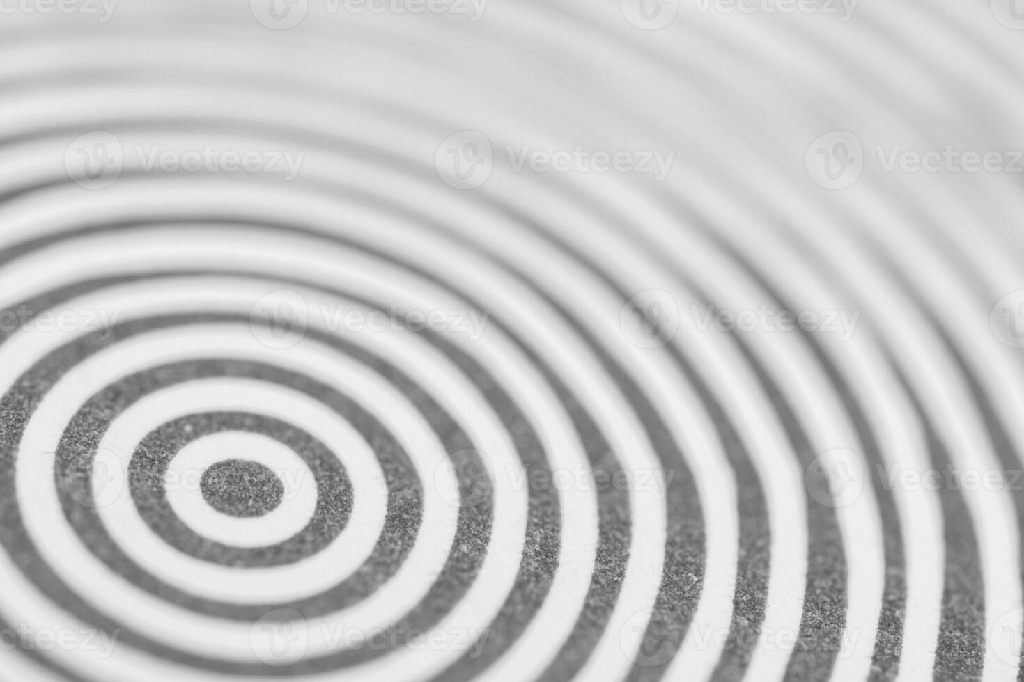 Abstract black and white concentric circles creating a hypnotic pattern. Ideal for backgrounds, concepts of focus, repetition, optical illusions, or design themes photo