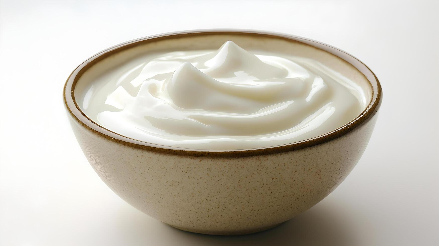 A bowl of yogurt on a white surface photo
