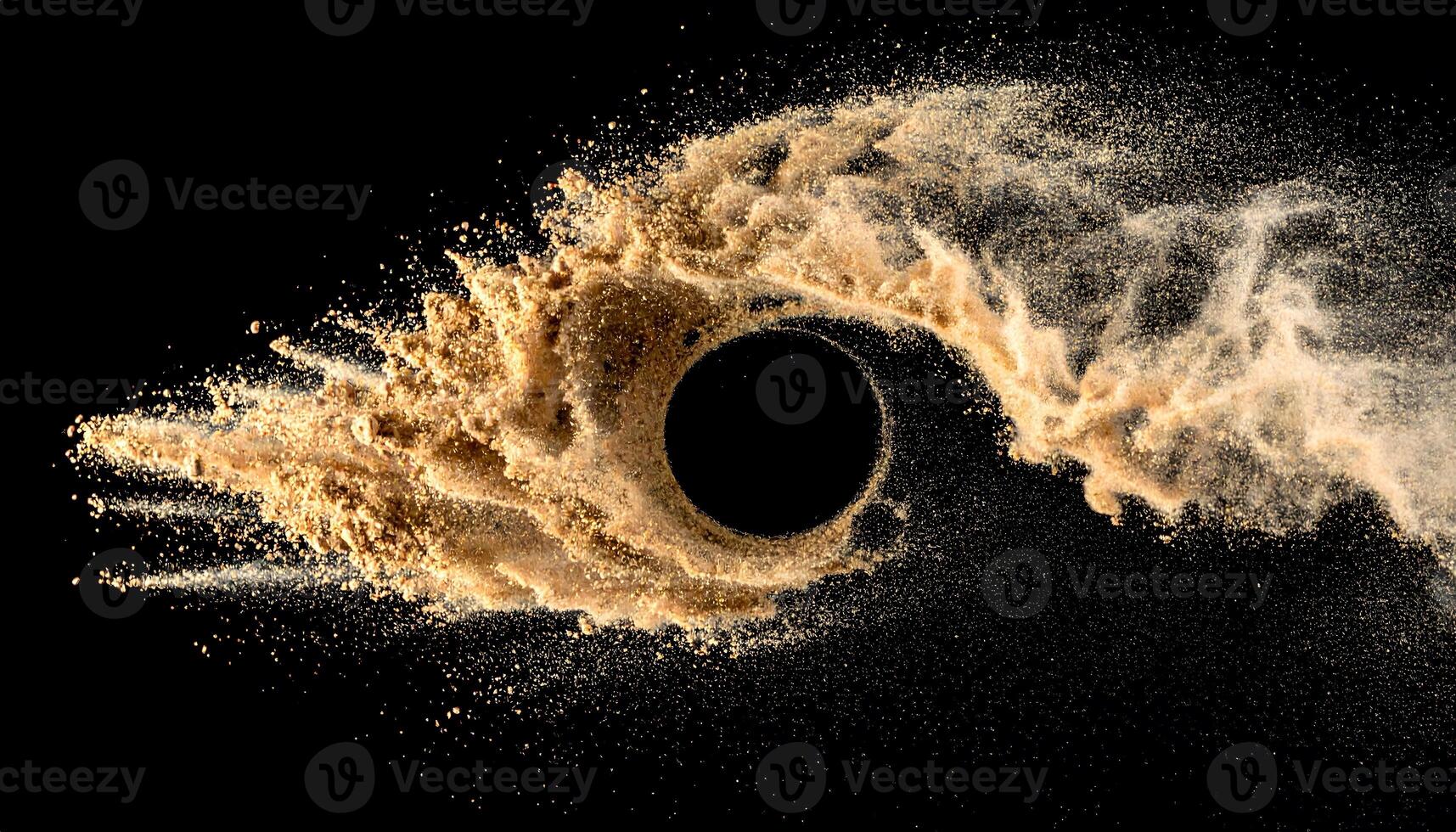 Golden sand bursts into the air against a black background, captured with high-speed motion. A dynamic, abstract display of fine particles, perfect for design, texture, and visual effects. photo