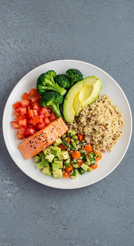 A plate of food with vegetables, rice, and salmon photo