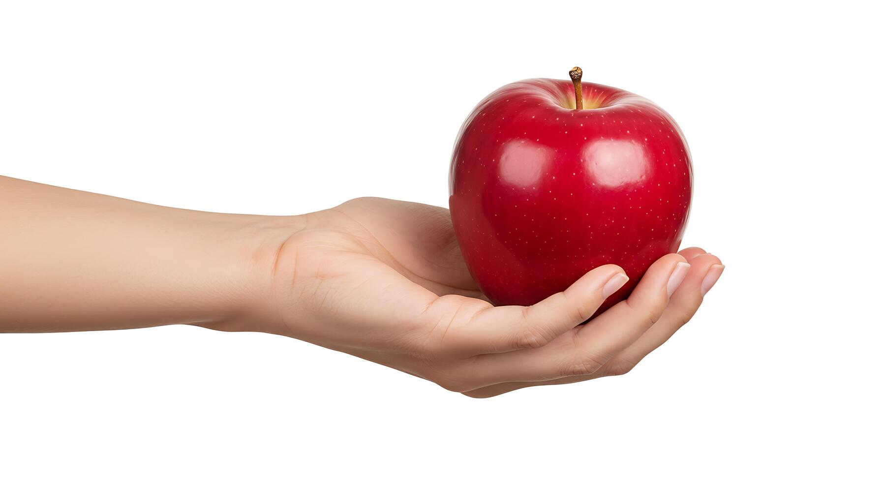 A person holding a red apple in their hand photo