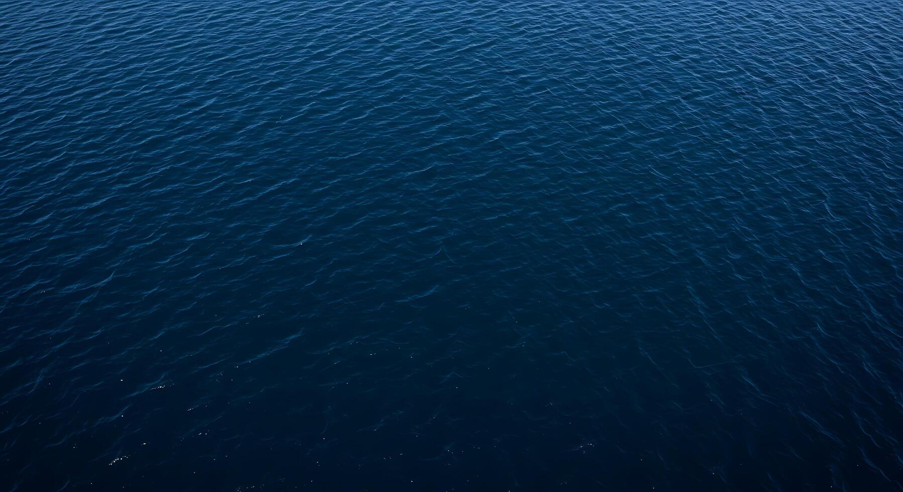 An aerial view of the ocean with a boat in the middle photo