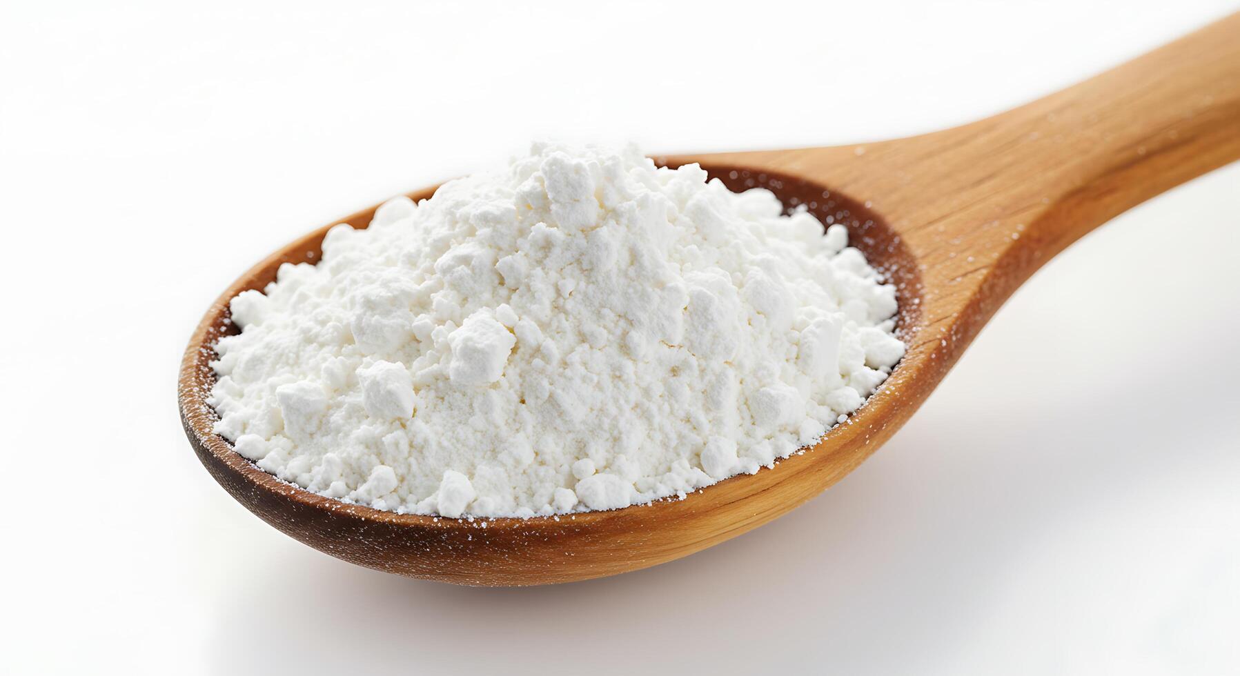 A spoon full of white powder on a white surface photo