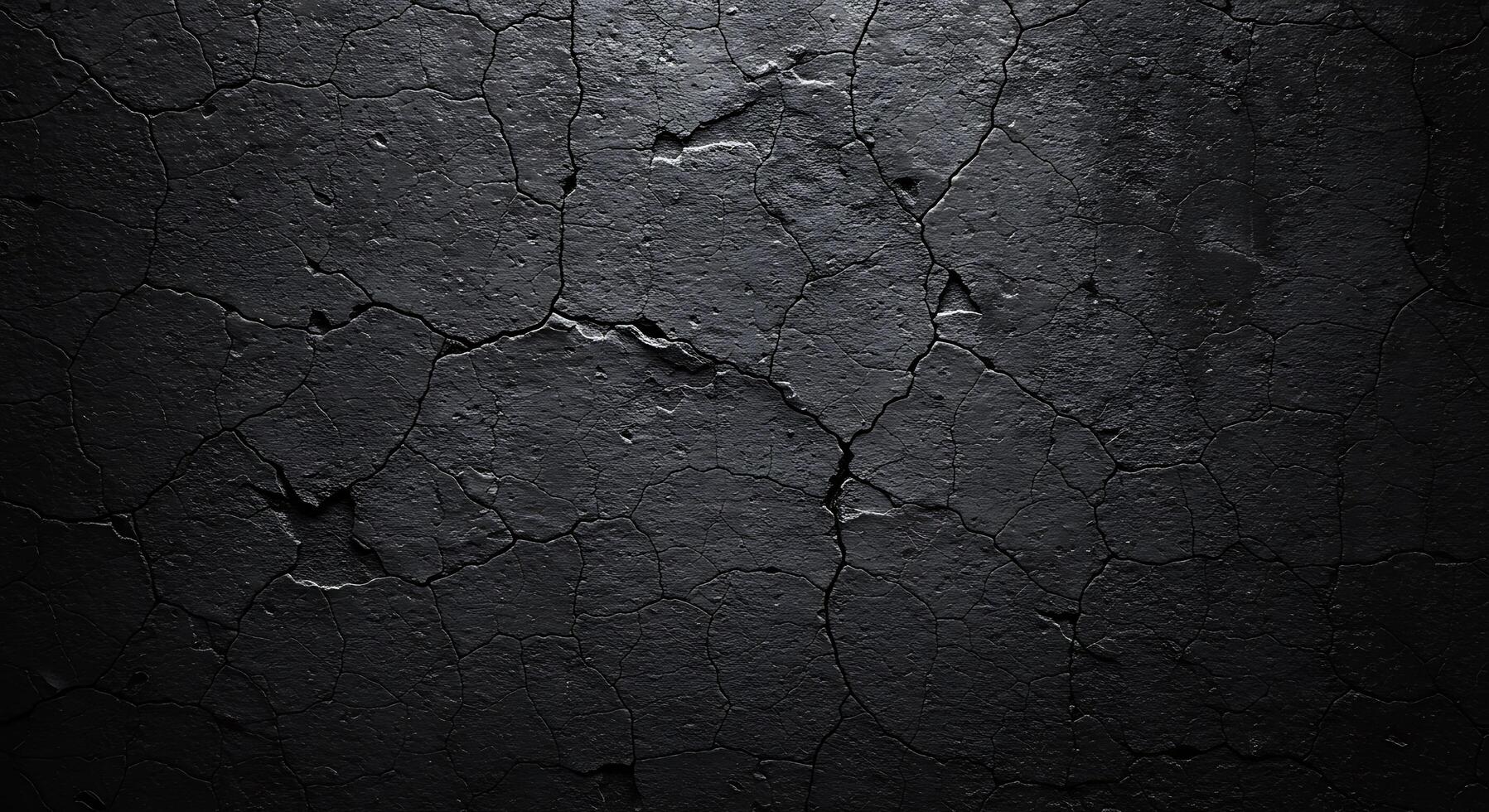 A black wall with cracked paint and a dark background photo