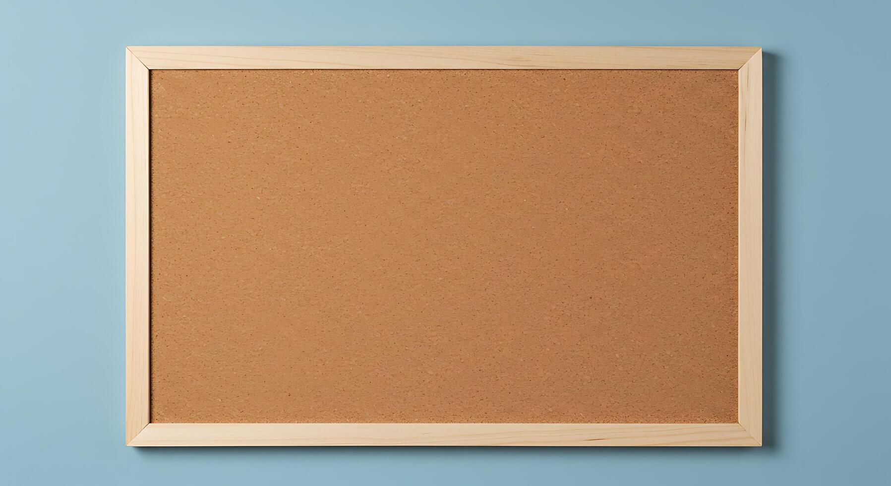 Wooden frame on blue background with cork board photo