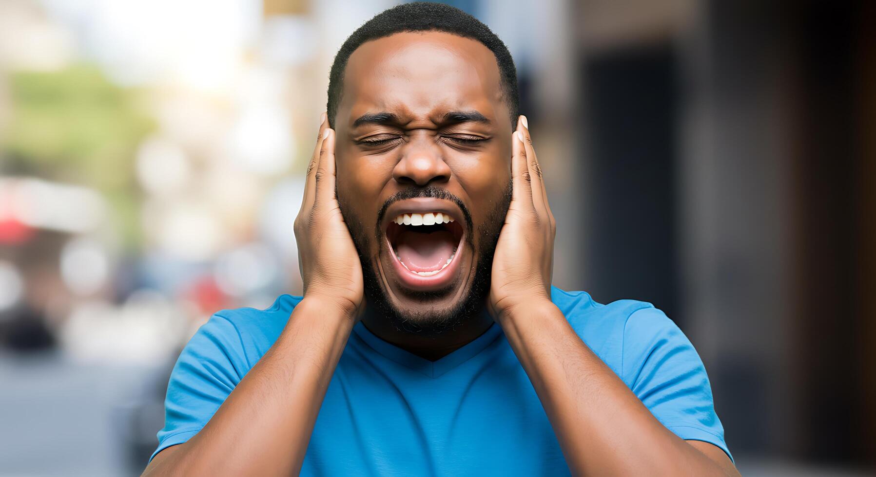 A man is screaming and holding his head photo
