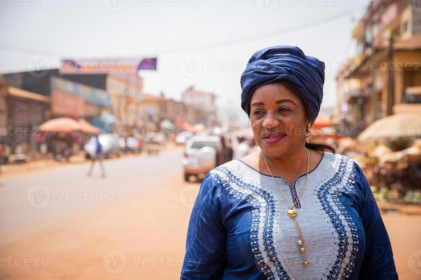 Portrait of a beautiful mature african lady in the city center in africa photo