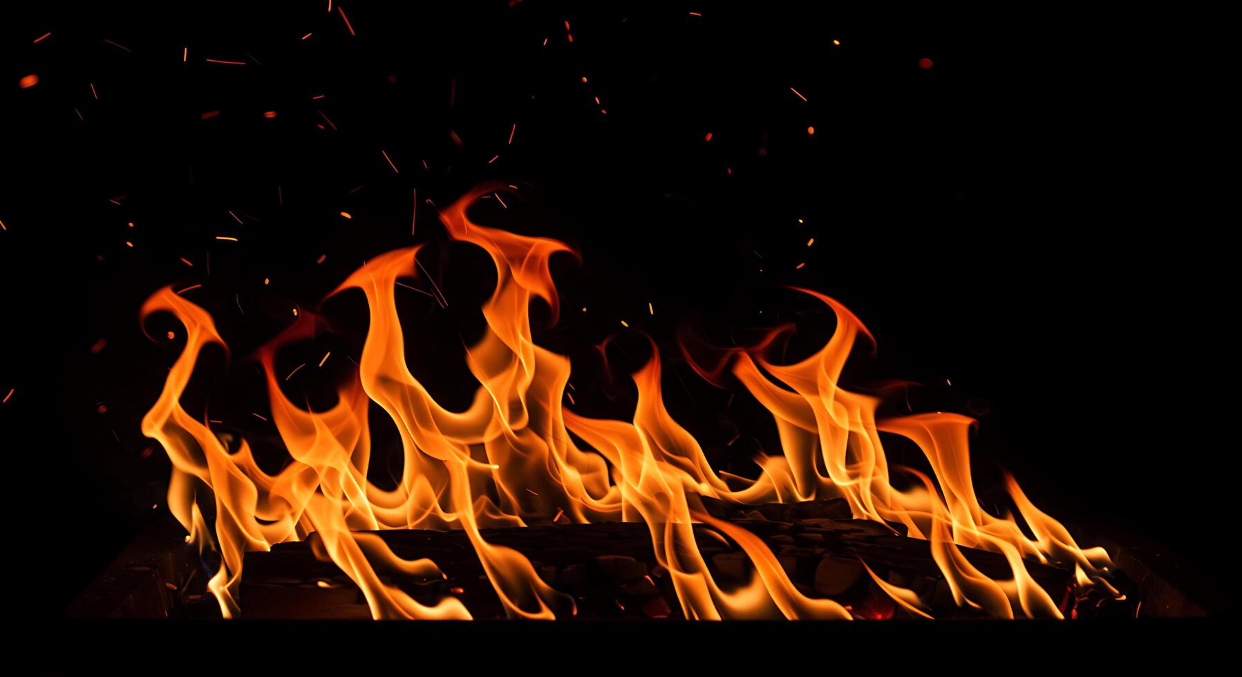 A fire is burning in the dark with flames photo