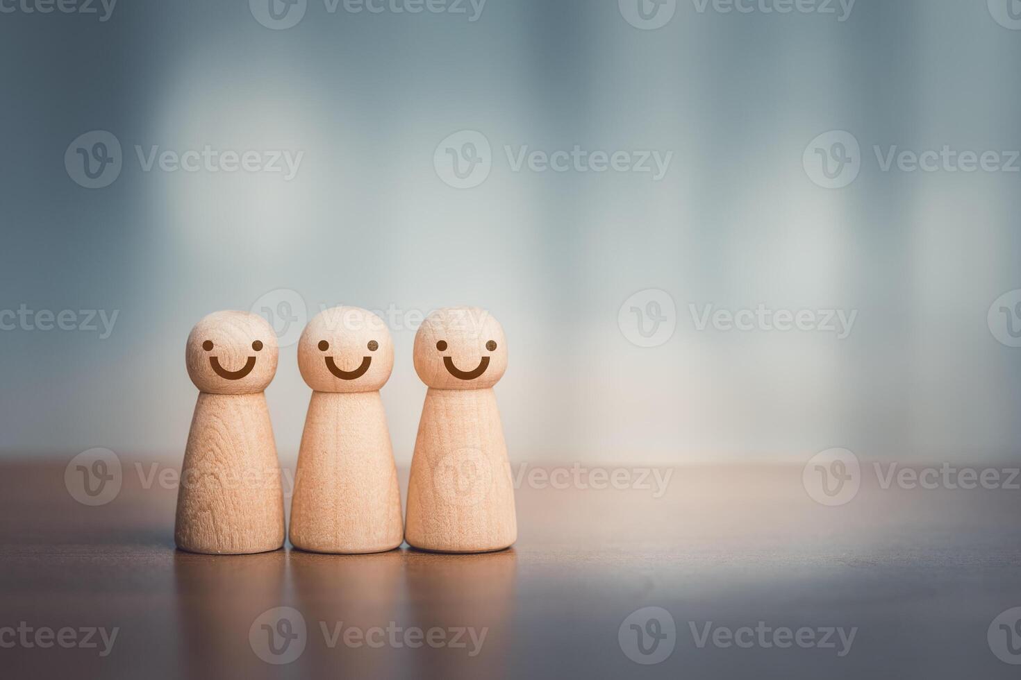 Wooden people with smiley faces on the table. Business concept photo