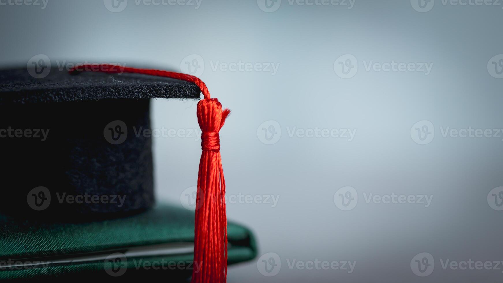 A Graduation Cap Resting on a Diploma, Academic Achievement Concept photo