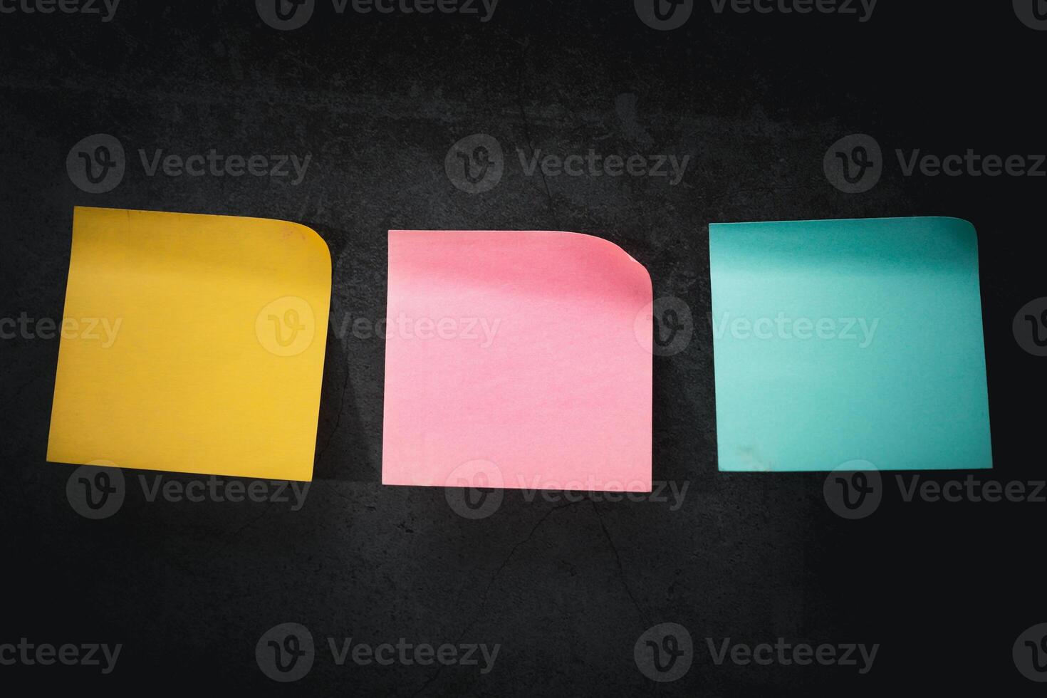 Colorful Post-it Notes Stuck on a Dark-Toned Background photo