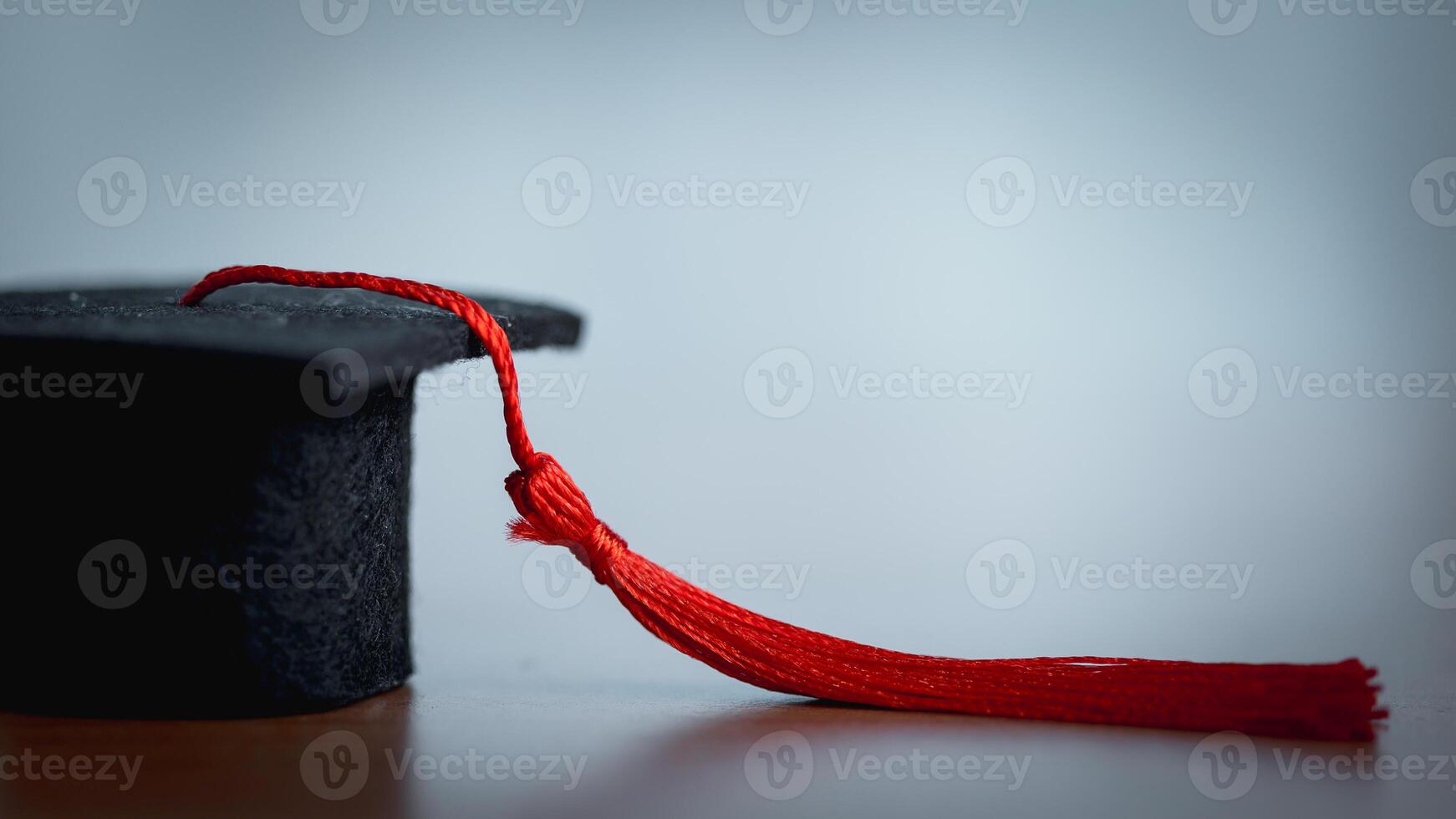 Graduation cap and red tassel on a white background. photo