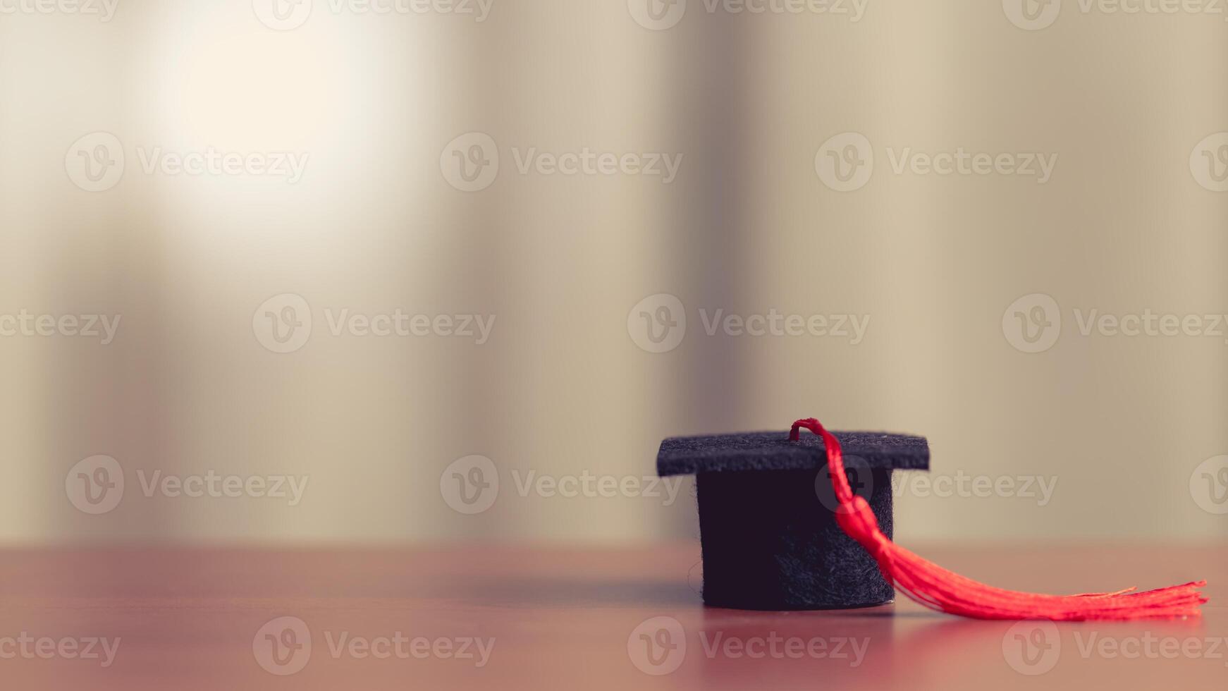 Graduation Cap on Wooden Table in Warm Sunset Glow with Copy Space photo