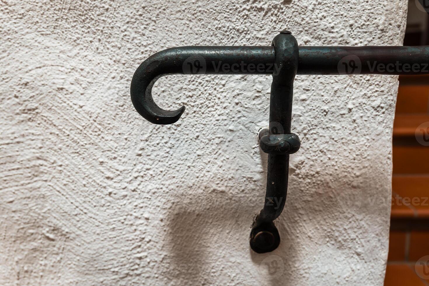 Old iron hook showcasing rustic craftsmanship in a vintage setting of natural textures and subdued colors photo