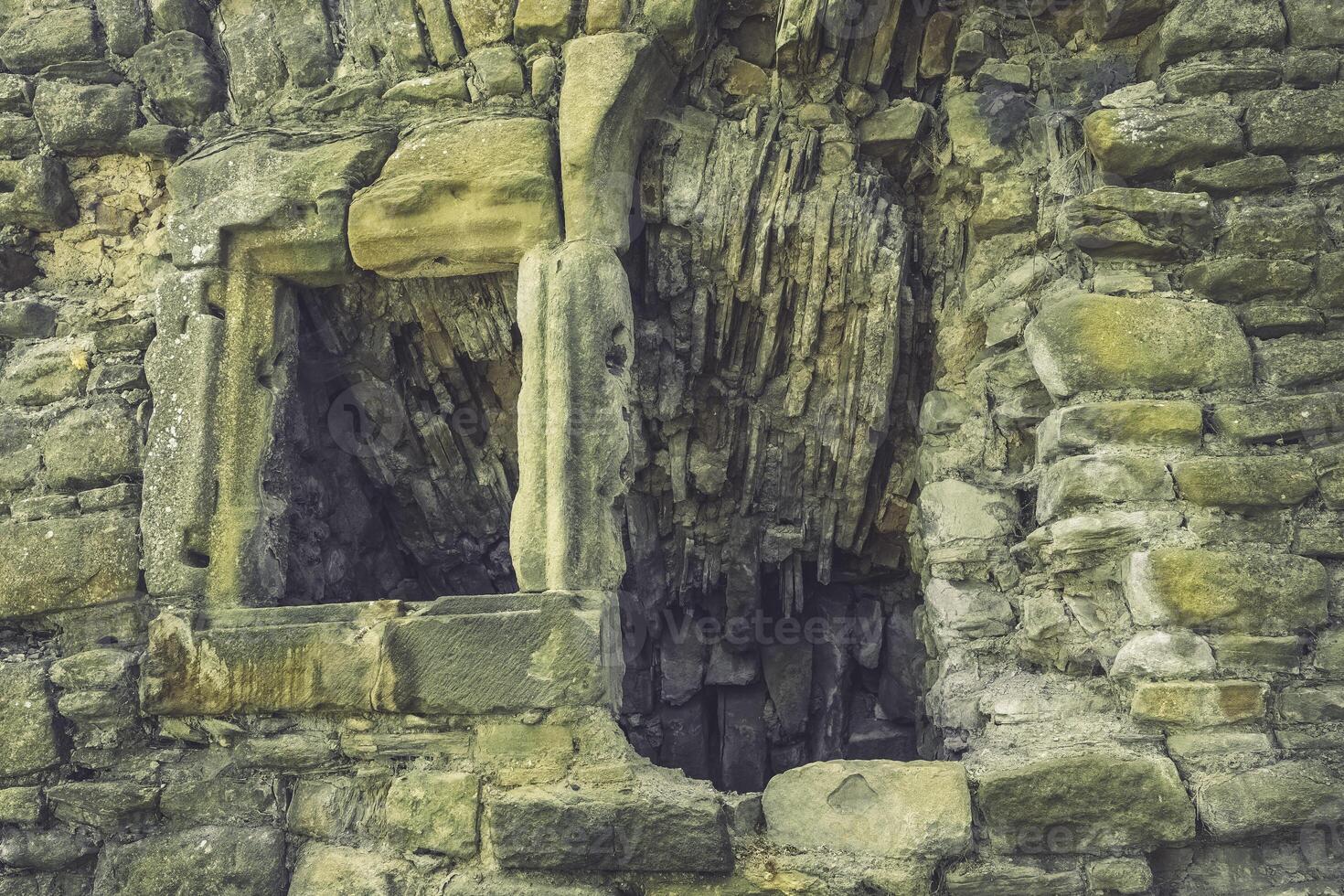 Ancient stone walls reveal stories of time in a forgotten castle courtyard bathed in soft sunlight photo