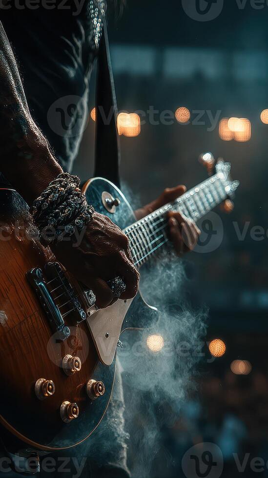 Guitarist performing at an energetic concert with dramatic lighting and an enthusiastic crowd during the evening photo