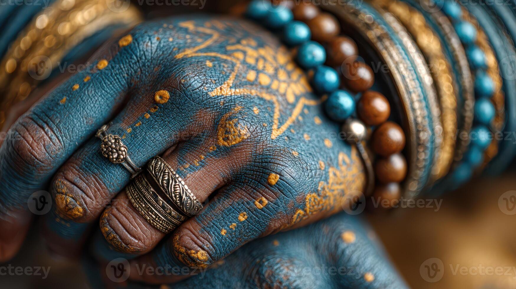 Hands adorned with intricate henna designs and vibrant jewelry showcase cultural artistry and tradition at a vibrant celebration photo