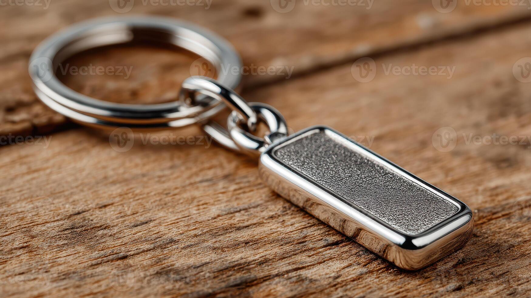 Keychain with rectangular metallic charm on wooden surface showcasing detailed craftsmanship and modern design elements photo