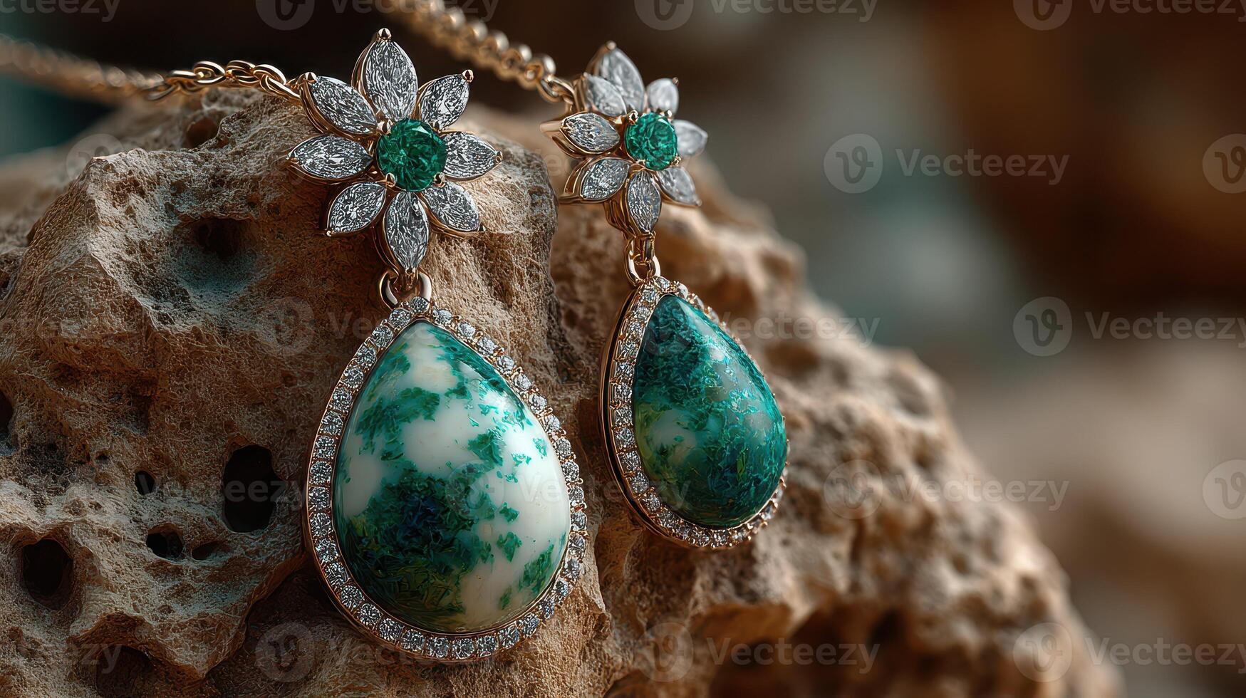 Elegant green gemstone earrings displayed on a textured stone surface in natural light photo