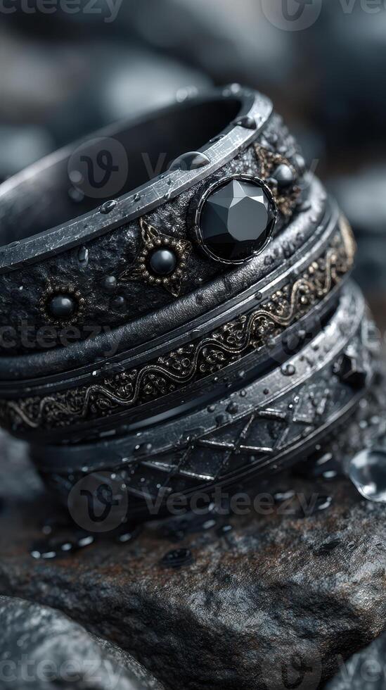 Beautifully crafted rings with intricate designs resting on a stone surface with water droplets, showcasing elegance and artistry photo
