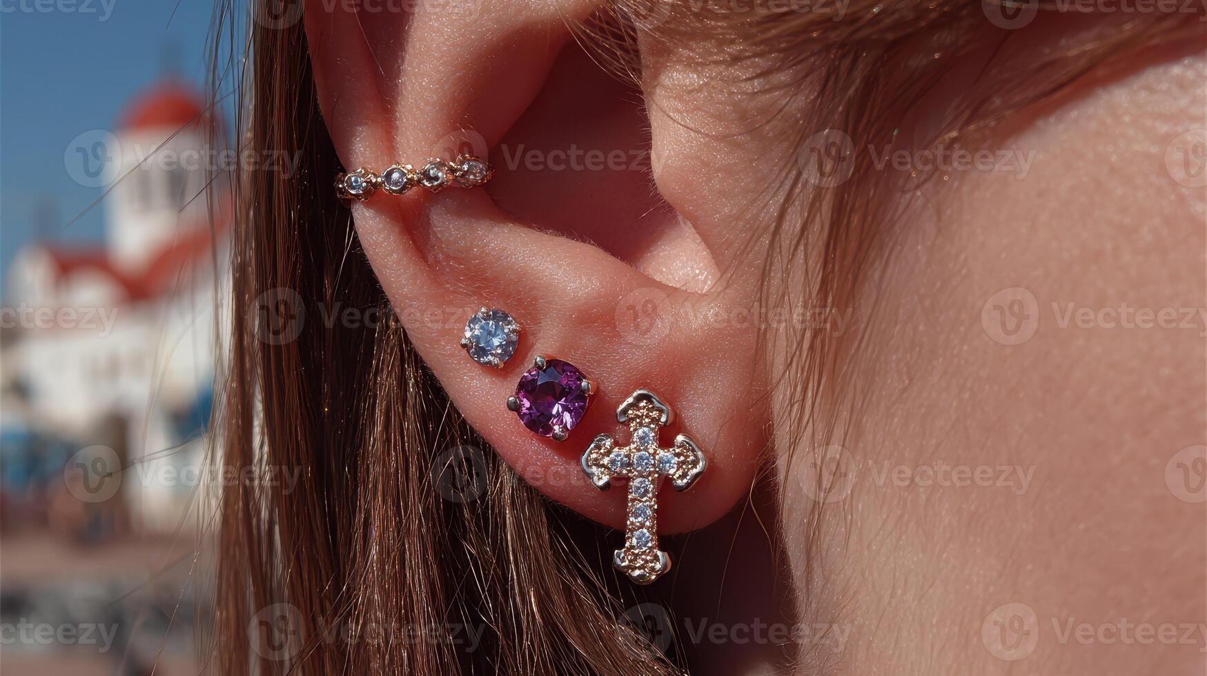 Unique ear jewelry displayed against a charming coastal background during sunny weather photo