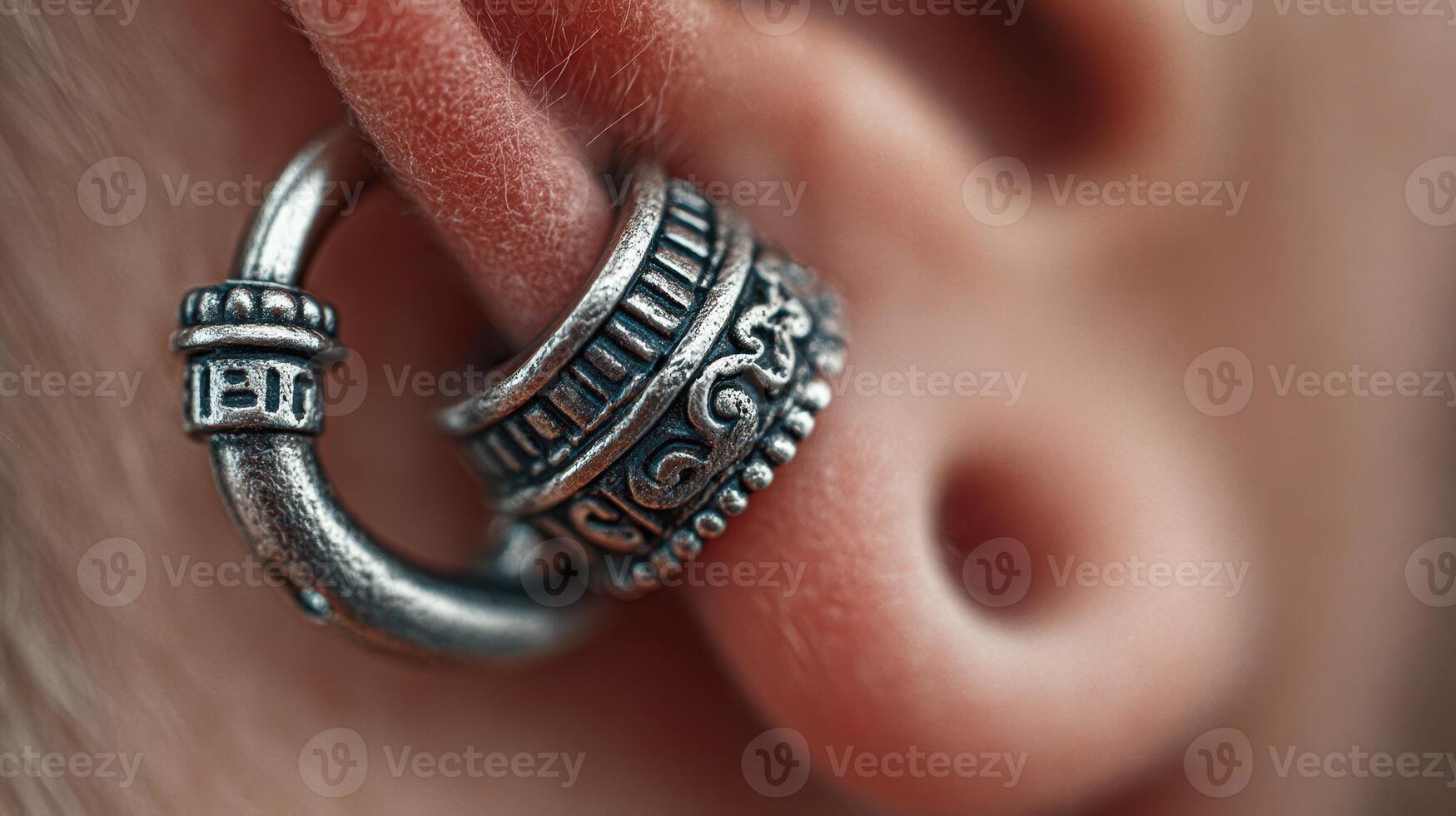 Close-up of decorative ear piercing jewelry showcasing intricate design details and texture photo