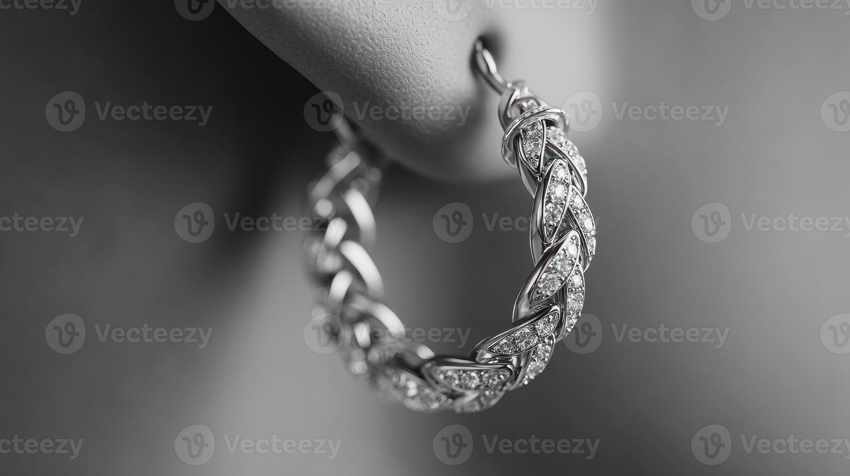 Elegant silver hoop earring adorned with sparkling gemstones showcased in detailed close-up photo