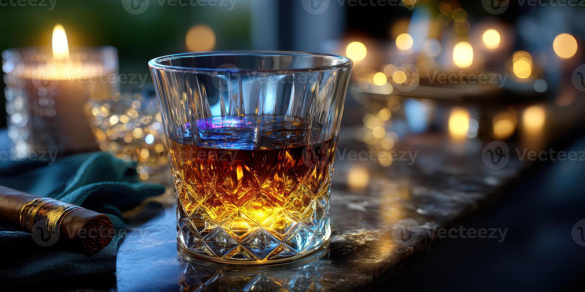 Glass of amber whiskey beside a lit candle on a marble table in a cozy setting photo