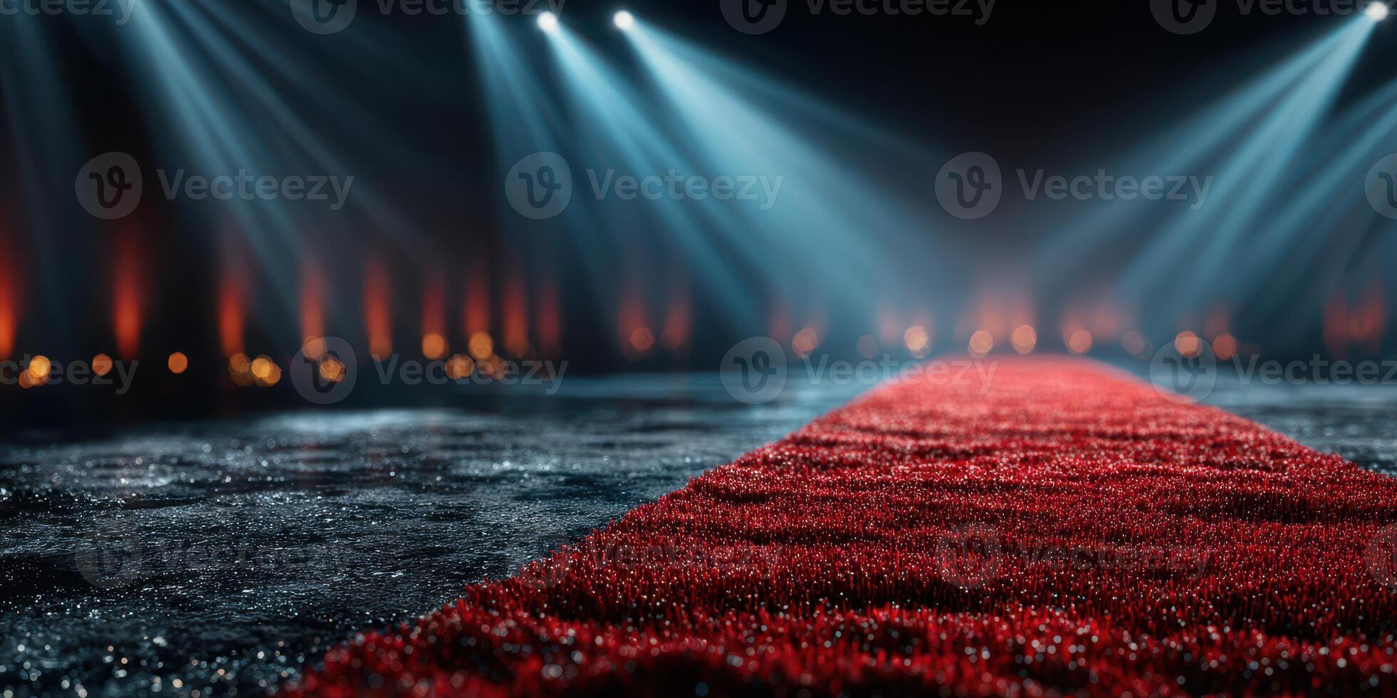 Elegant red carpet leads to a spotlighted stage for a glamorous event in a beautifully lit venue photo
