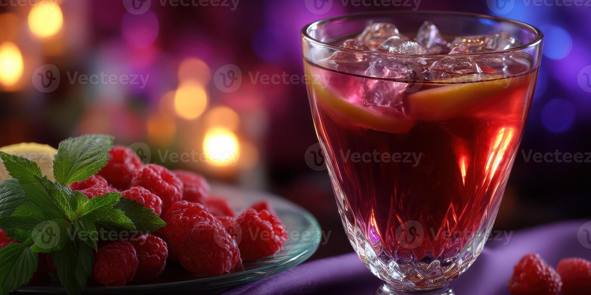 Refreshing berry drink served in a glass with fresh raspberries and mint on a vibrant table photo