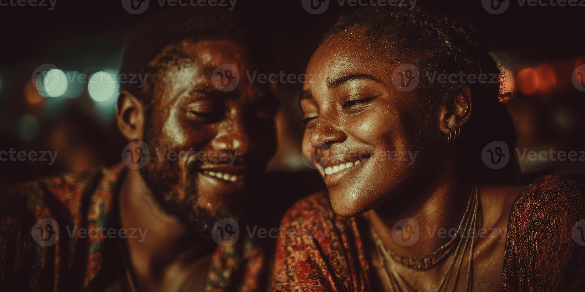 Couple enjoying a joyful moment under lights at a nighttime gathering by the waterfront photo