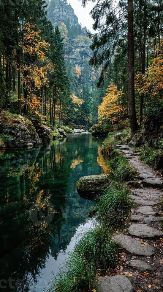 Majestic autumn landscape by a tranquil river surrounded by vibrant foliage and towering cliffs at mid-afternoon photo