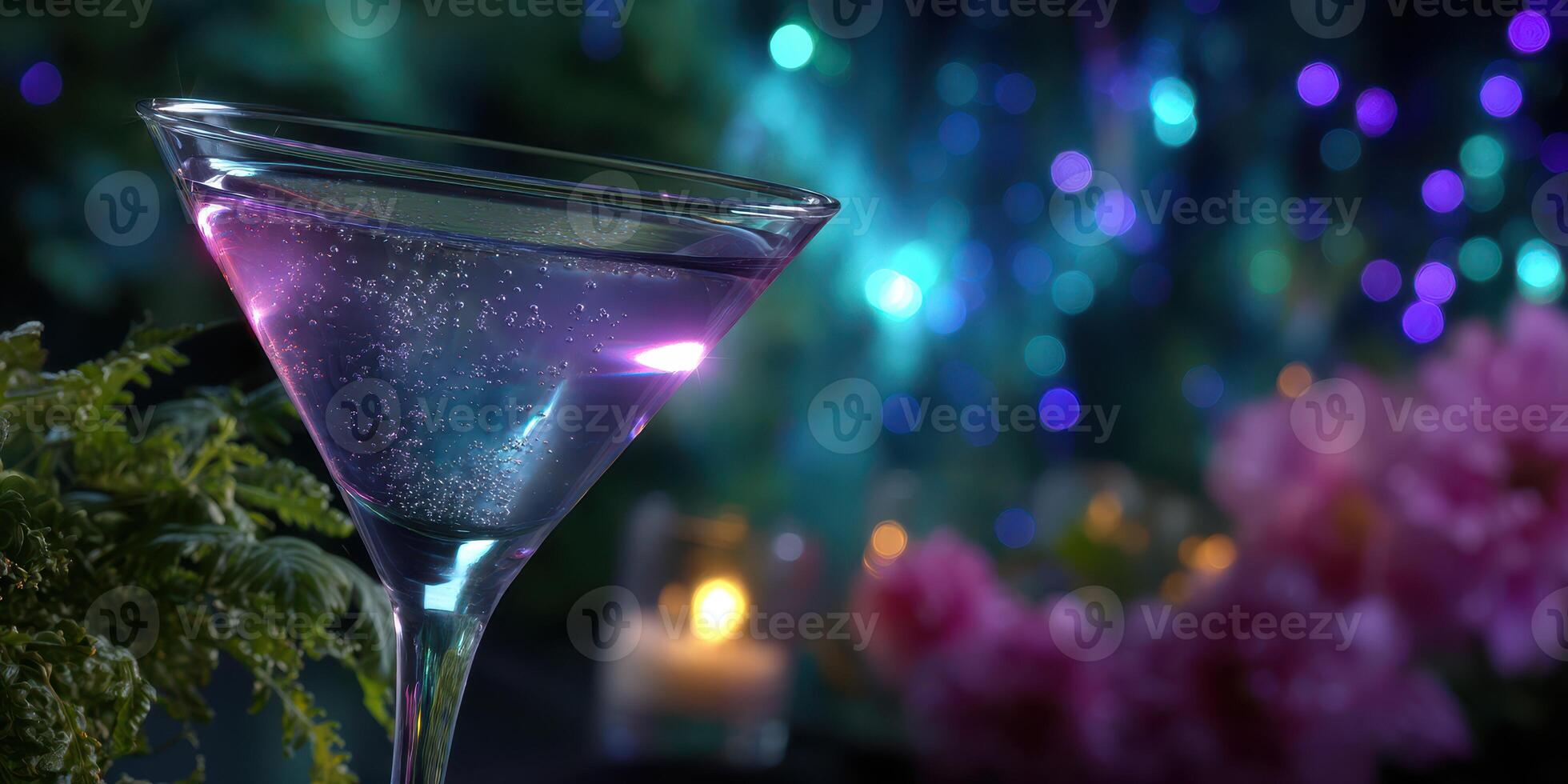 Elegant cocktail in a glass with purple hue set against a vibrant, colorful background during an evening gathering photo
