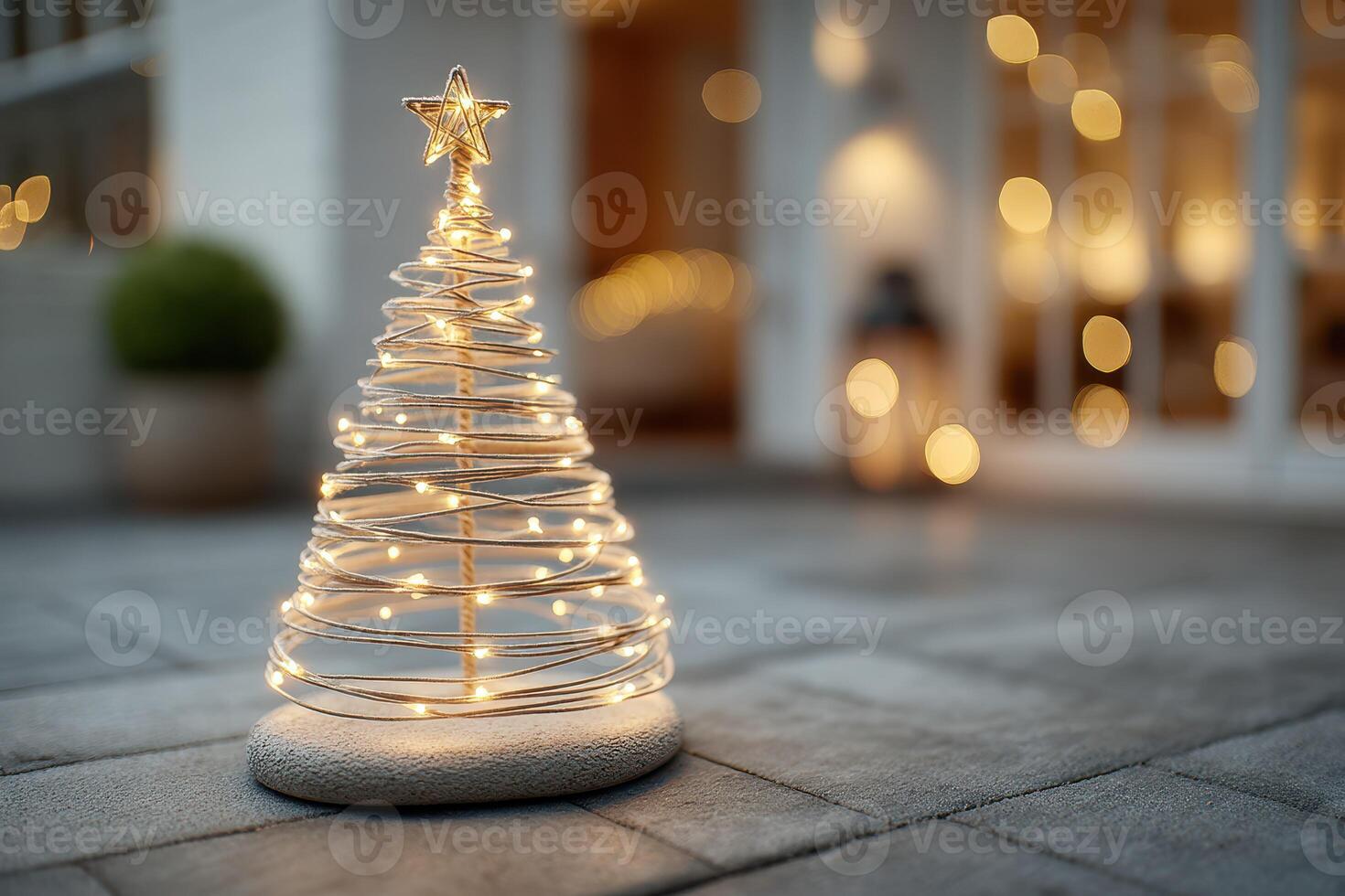 Holiday decorations showcase a glowing wire Christmas tree in a cozy outdoor setting during a festive evening photo