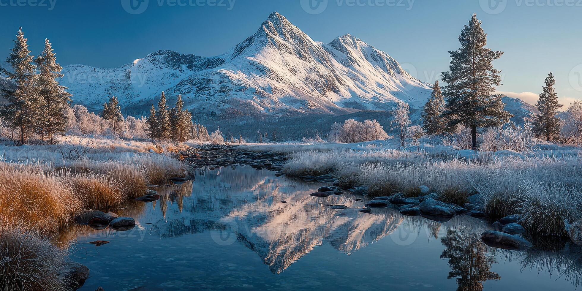 Snowy mountain landscape with a serene river reflecting the peaks during a clear winter morning in a tranquil wilderness area photo