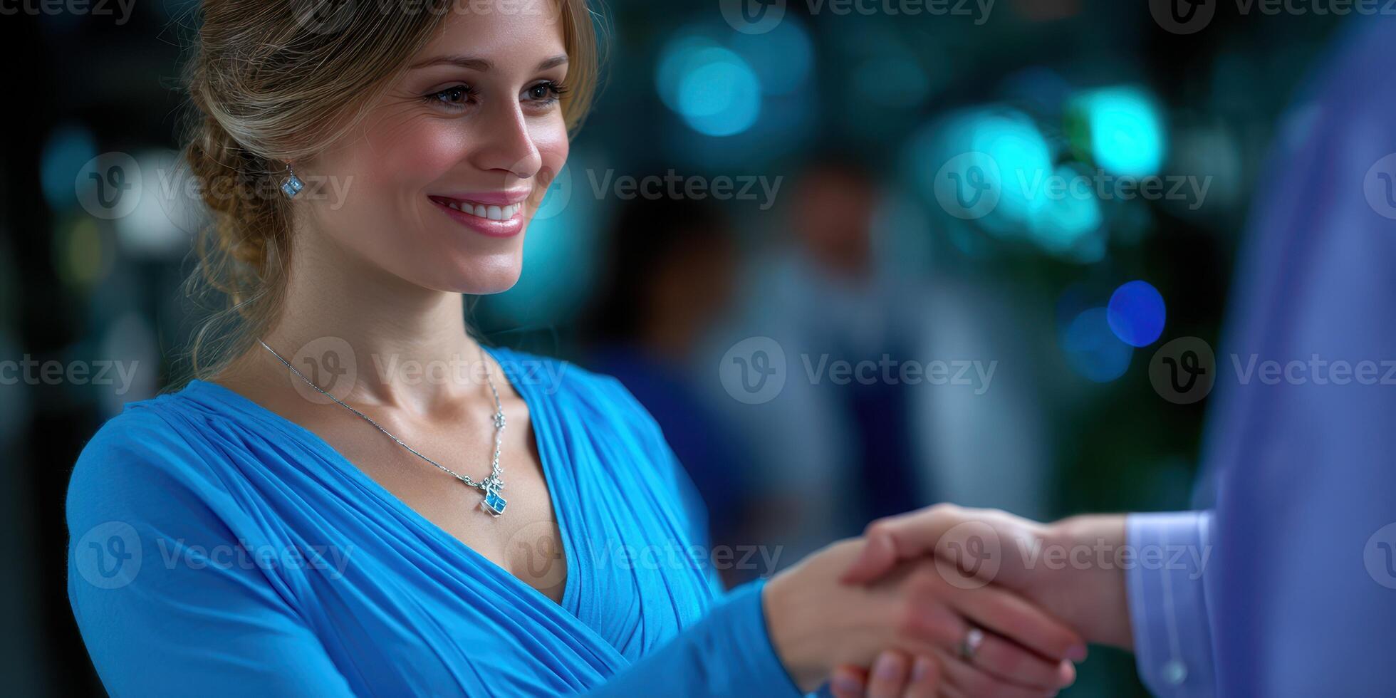 Professional woman shakes hands with a man in a modern office environment during a business meeting at night photo