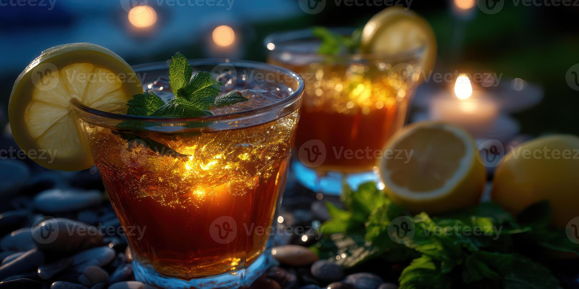 Refreshing iced tea drinks with lemon and mint in a serene evening setting by the water photo