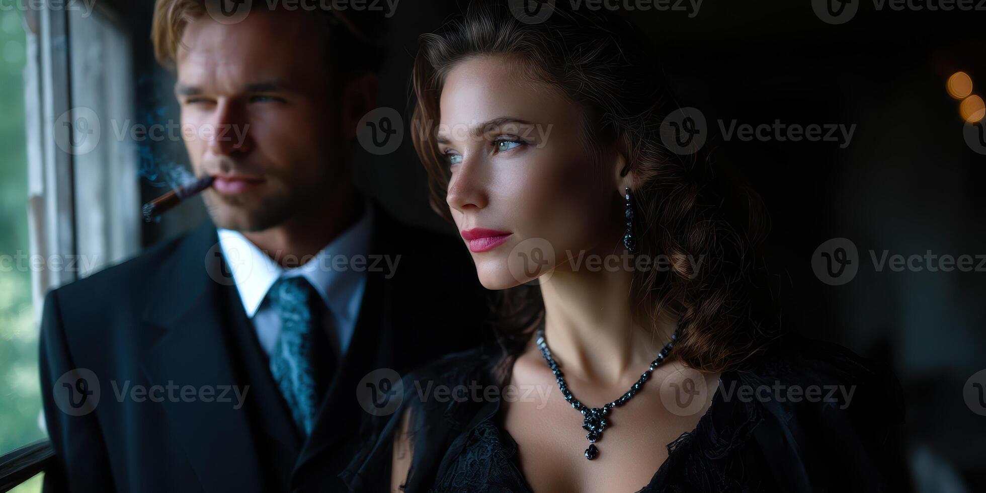 Elegant couple gazing out a window in vintage attire during a moody evening in an upscale setting photo