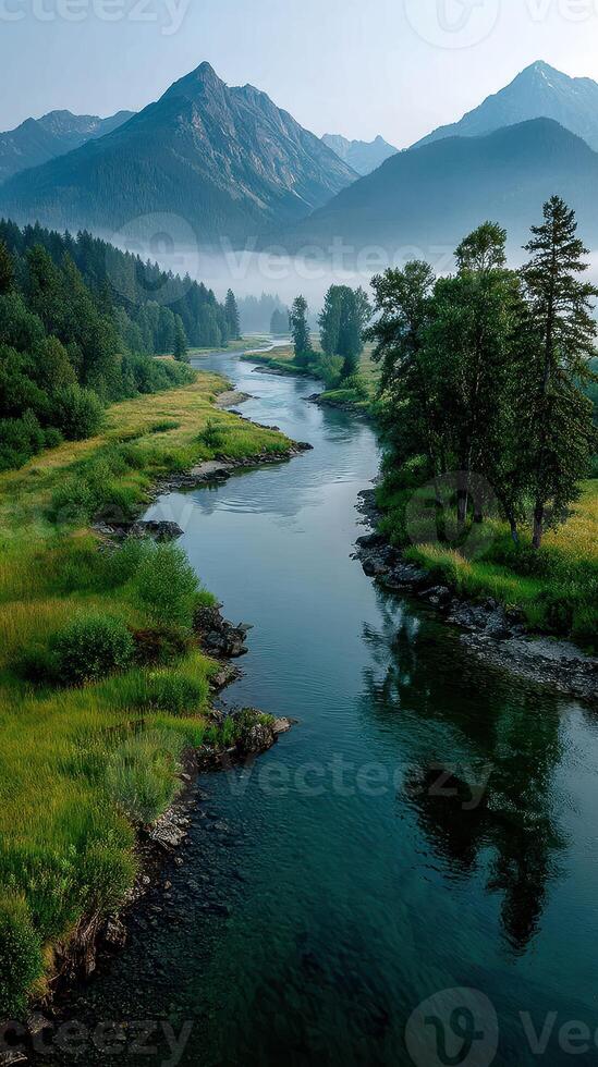 Majestic river winding through lush valley and mountains at dawn under soft light photo