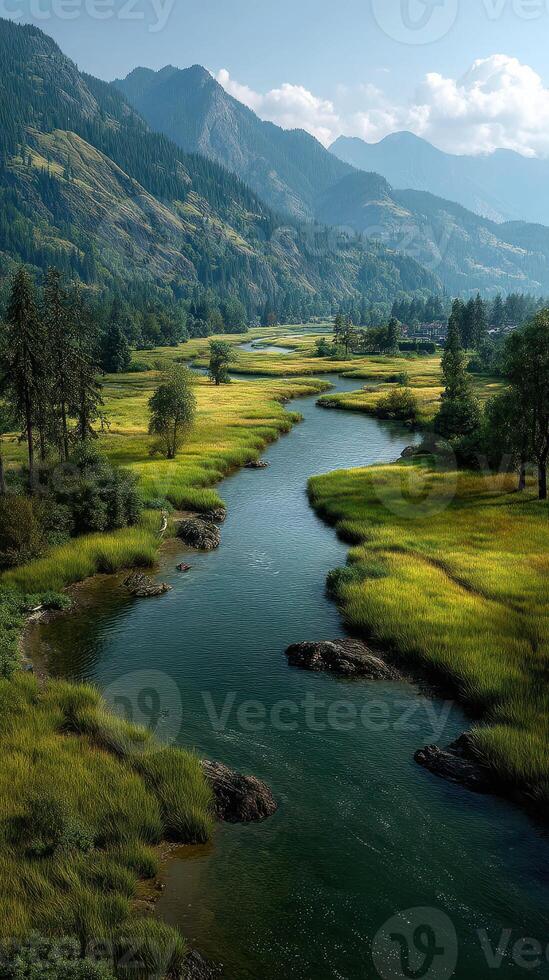 Serene river flows through green meadows under majestic mountains in bright daylight photo