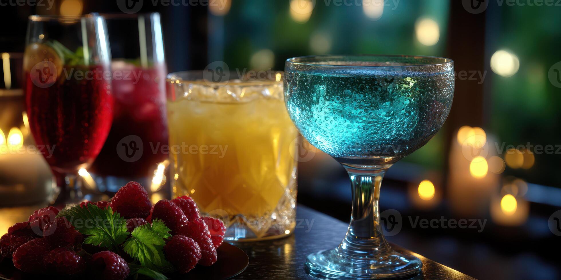 Elegant cocktail setup with colorful drinks and fresh raspberries at a cozy evening gathering photo