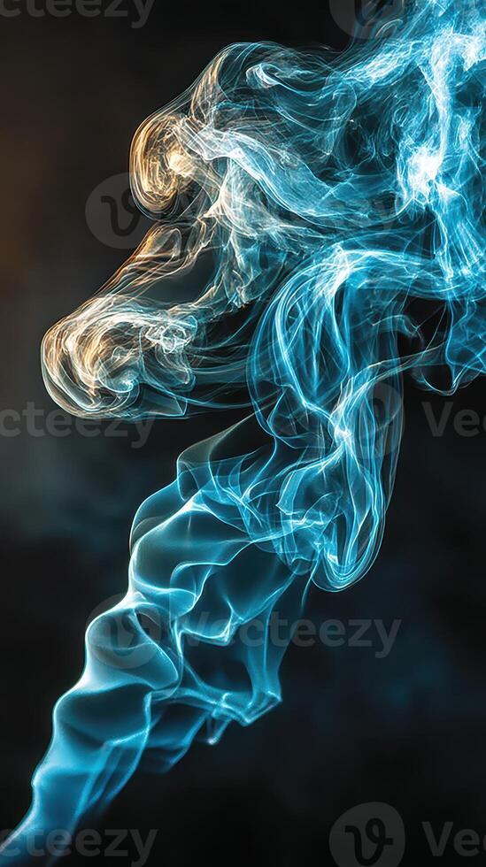 Ethereal wisps of blue and golden smoke swirling against a dark background during a still moment photo
