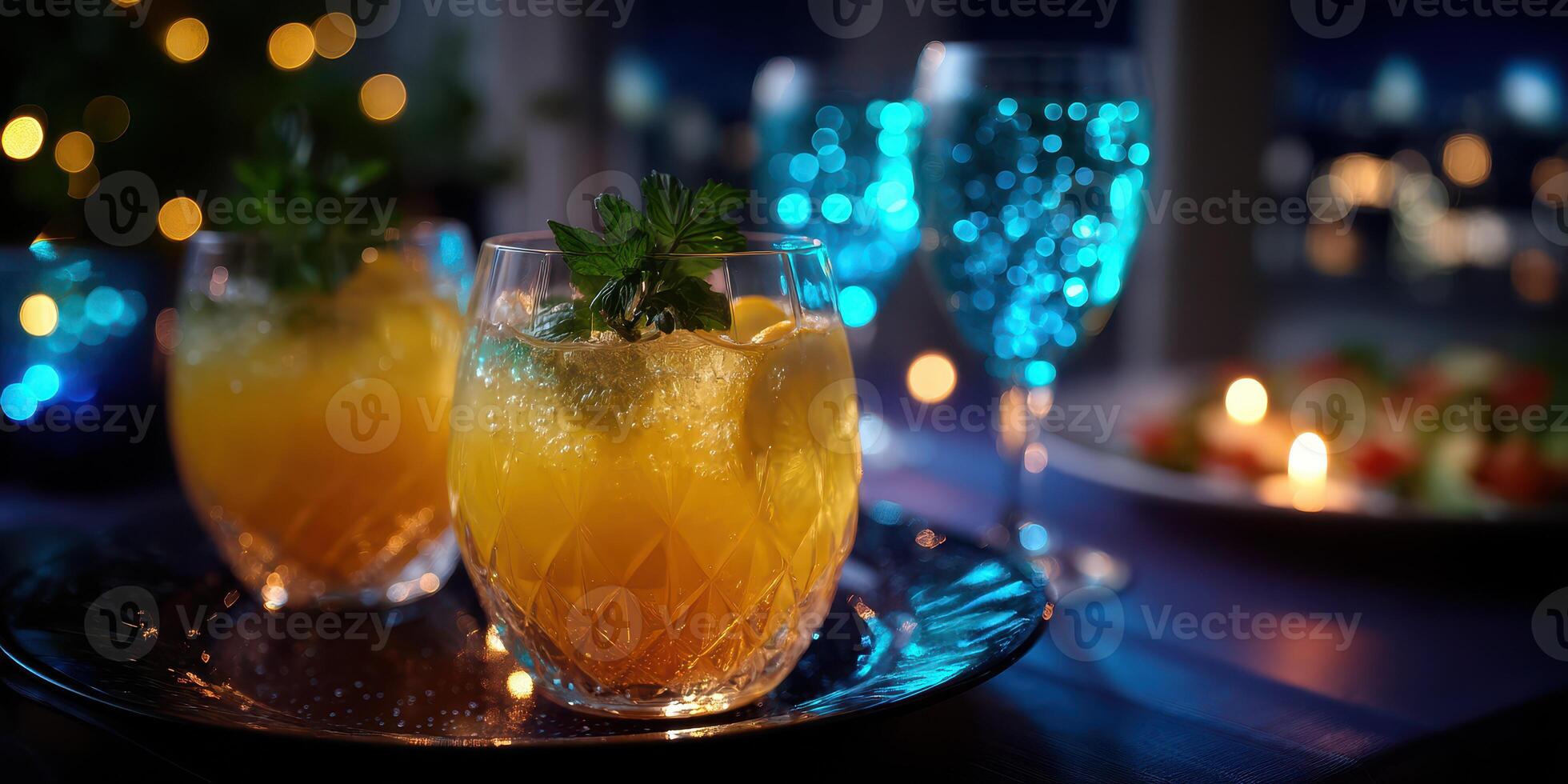 Bright cocktails and elegant glassware create a festive atmosphere at a nighttime gathering with city views photo