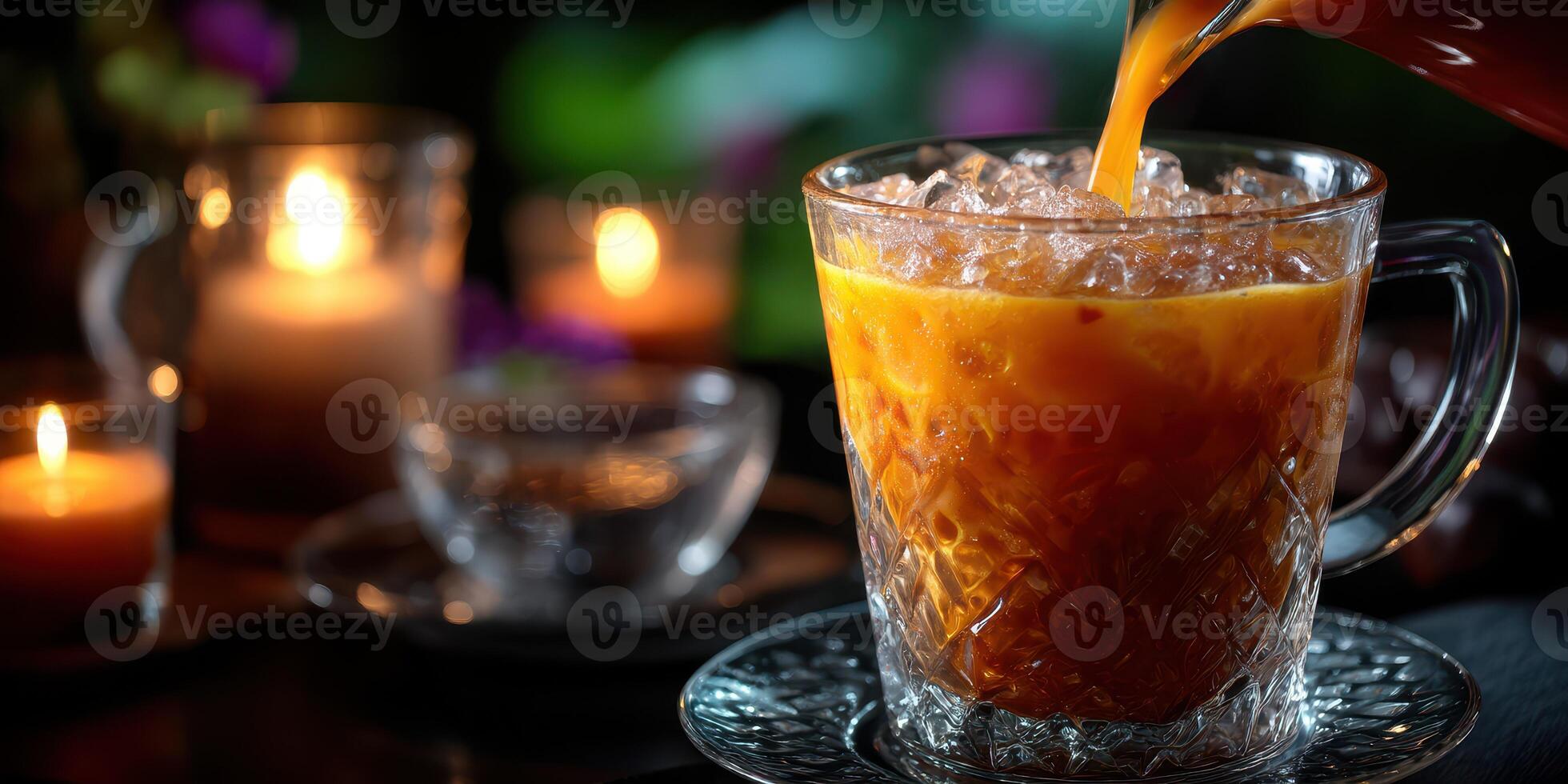 Refreshing iced beverage served in a glass with ice, illuminated by candlelight during a cozy evening gathering photo