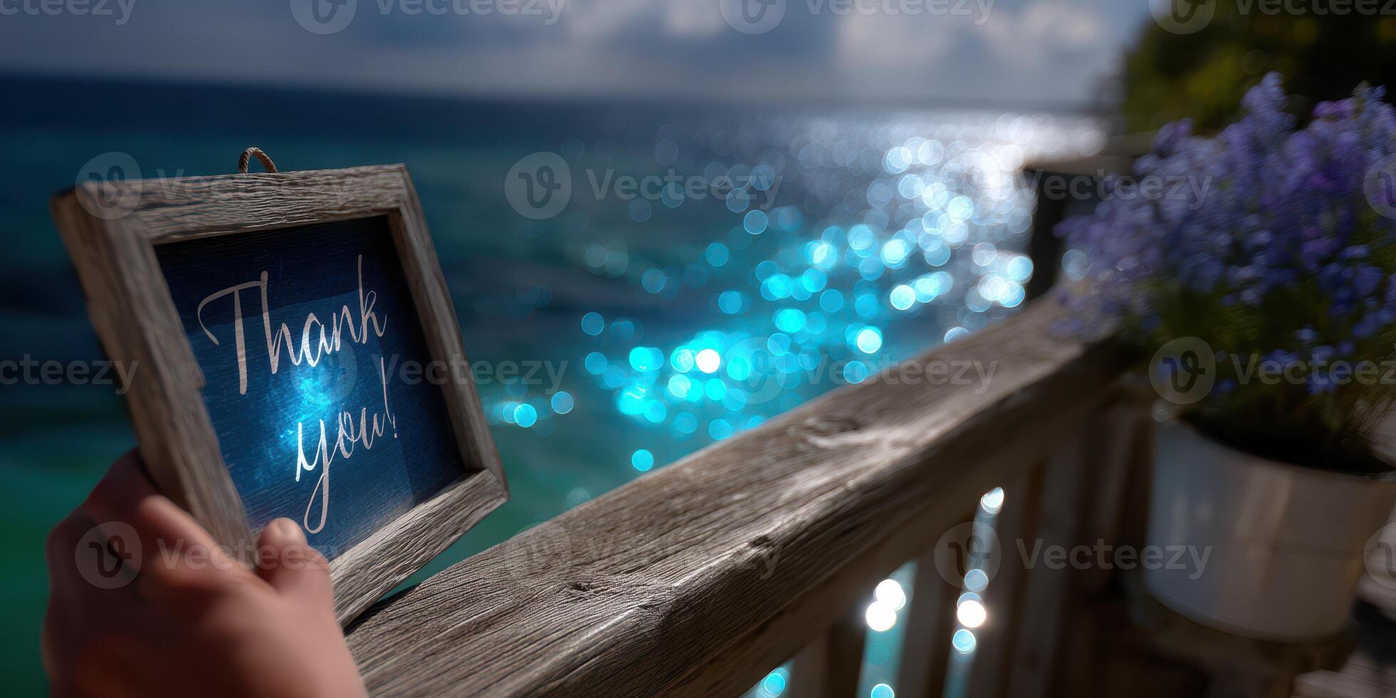 Thankful gesture by the ocean with sunlight sparkling on the water during a serene afternoon photo