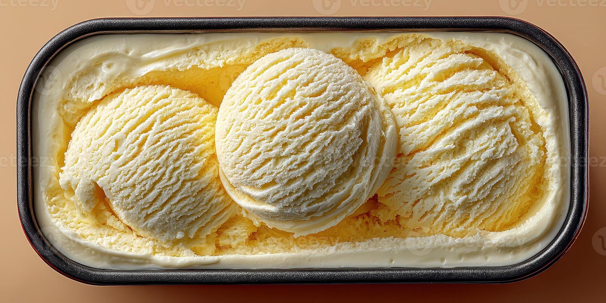 Delicious, creamy vanilla ice cream served in a black container with three perfect scoops ready to enjoy photo