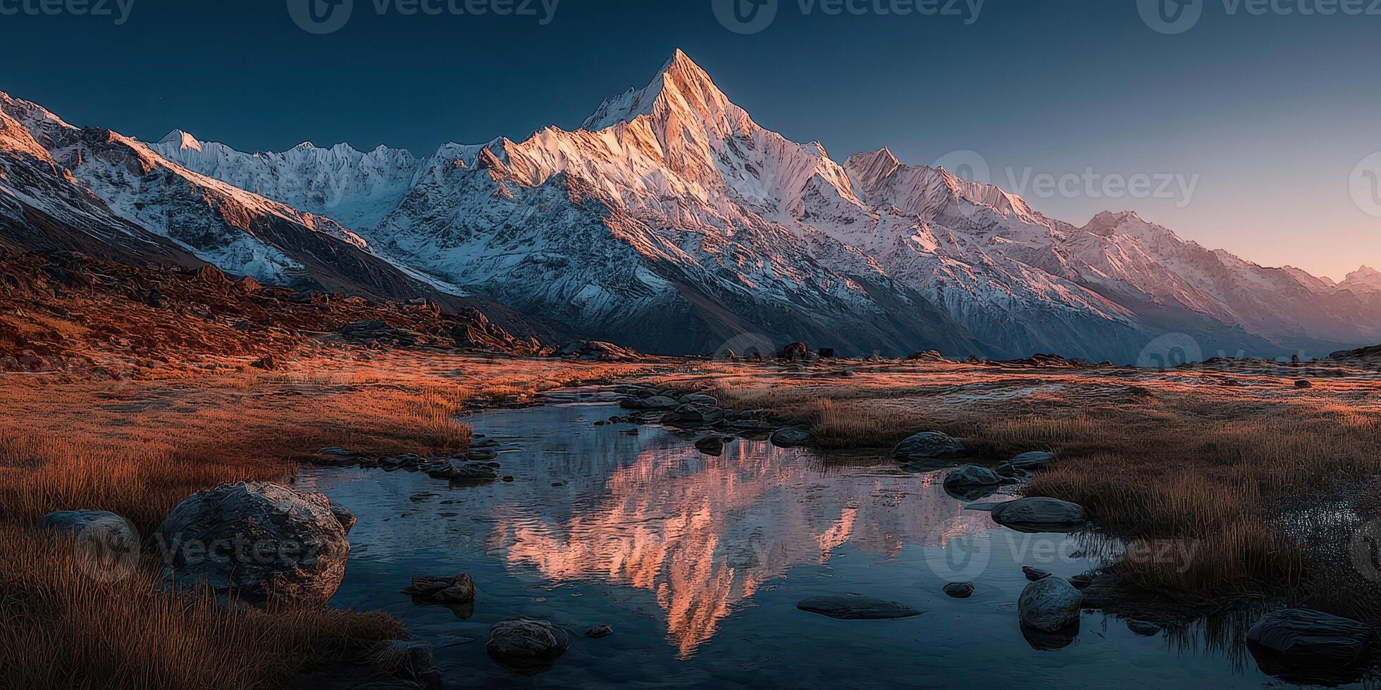 Majestic mountain peak reflected in calm stream at dawn in the wilderness photo