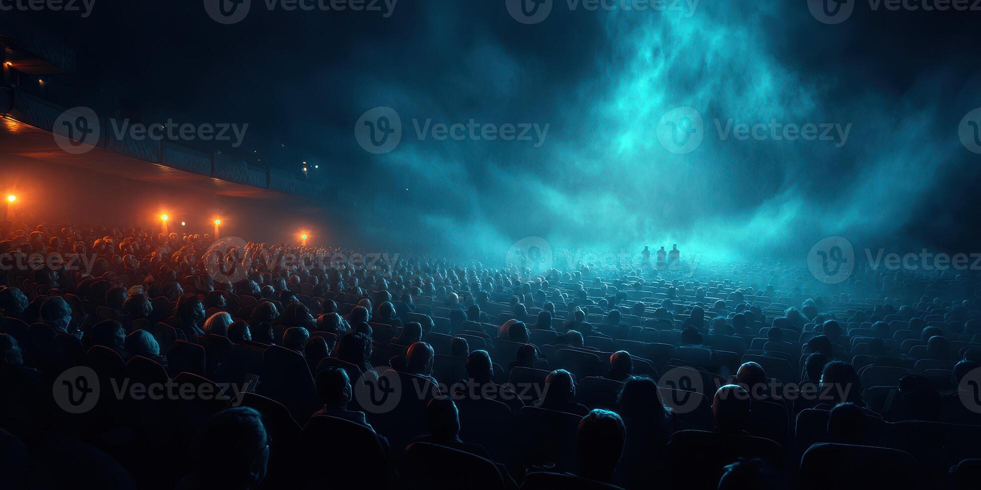 Large audience in a dark theater experiencing an immersive performance with fog and dramatic lighting at night photo