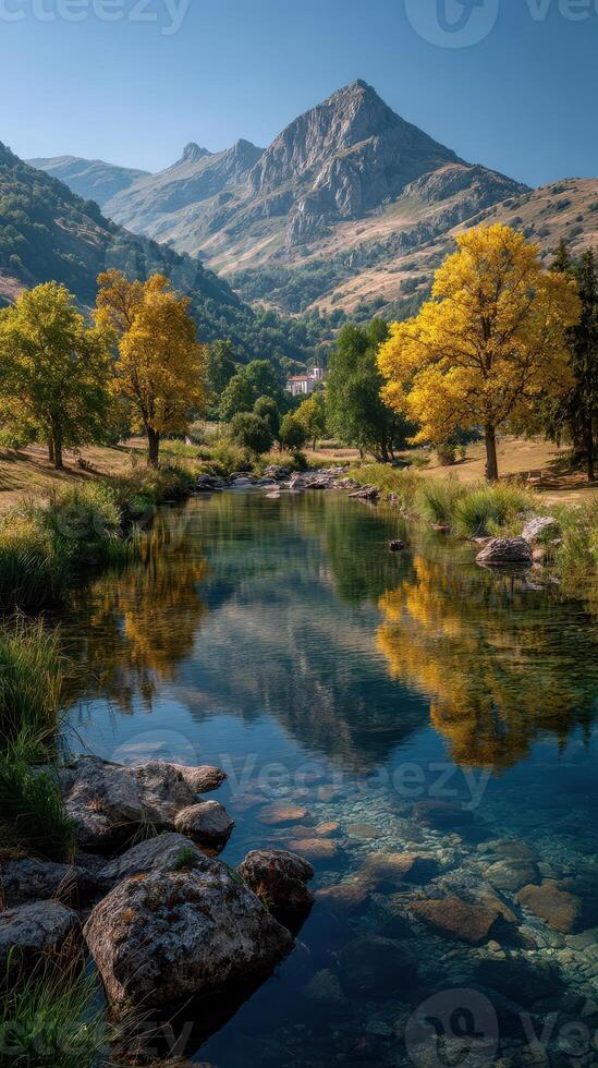 Scenic autumn landscape with reflecting river and mountains in the background during warm daylight photo